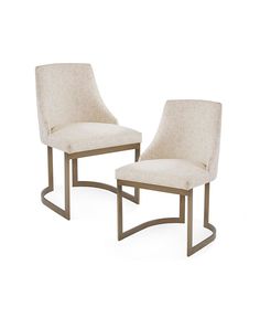 a pair of beige chairs sitting next to each other