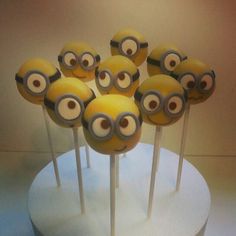 there are many yellow cake pops with eyes on them