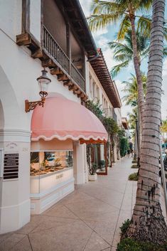 the outside of a restaurant with palm trees