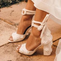 the bride's shoes are adorned with pearls