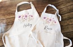 two personalized aprons with flowers on them