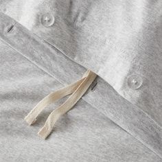 a close up view of a buttoned down shirt with tassels on it