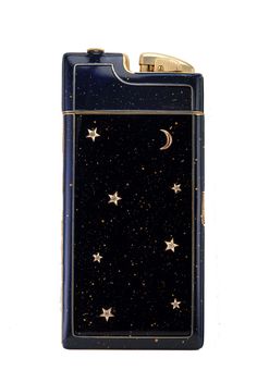 a black and gold lighter with stars on the bottom, moon in the sky above it