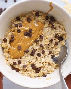 a bowl filled with oatmeal, chocolate chips and peanut butter on top