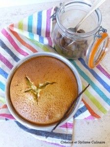 a cake sitting on top of a striped towel next to a jar of chocolate chips