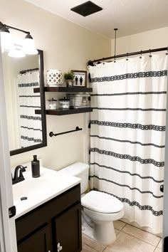 a white toilet sitting next to a bathroom sink