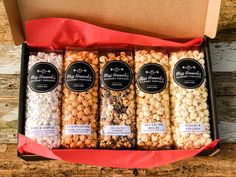 four different types of popcorn in a box