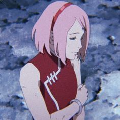 an anime character with pink hair wearing a red shirt and holding a football in her hand