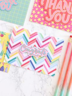 colorful stationery with pencils, notepad and thank you card on marble surface