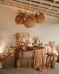 an arrangement of vases, candles and other items on a table in a room