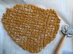 a piece of food that has been cut into squares and is next to a wrench