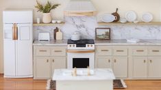 a white stove top oven sitting inside of a kitchen