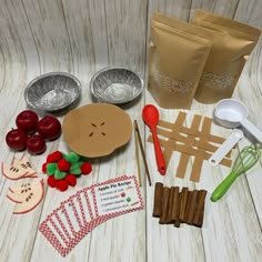 an assortment of food items are laid out on a wooden table next to paper bags and spoons