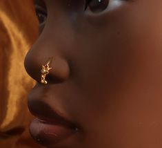 a close up of a child's nose with an ear piercing