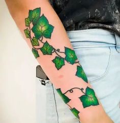 a person with a green tattoo on their arm