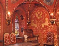 an ornately decorated room with red walls and chairs