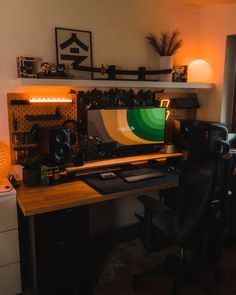 a desk with a computer monitor and speakers on top of it in a home office