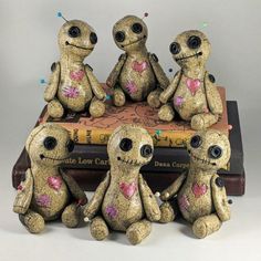 four little stuffed animals sitting on top of a book with lights in their ears and eyes