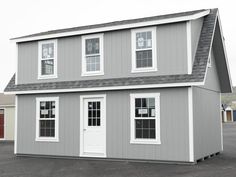 a gray two story house with white windows