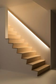 an empty room with some stairs lit up