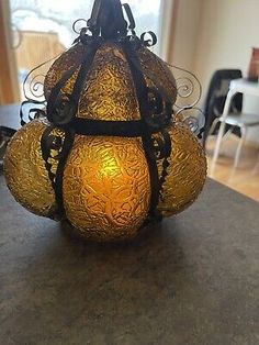 an old fashioned lamp is sitting on the table