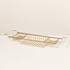 a gold metal shelf with two baskets on it