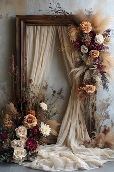 an artistic photo with flowers and feathers in front of a mirror on the floor next to it