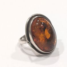 Magnificent vintage embossed Sterling Silver And Amber Ring Size 7.  The ring has a 925 stamp and an IJG maker's mark It is in great vintage condition. This cognac amber ring is absolutely beautiful and accented with embossed leaves on the side.  It measures 7/8" in length by 5/8" in width.  It weighs 9.4 grams.  It will come in a gift box Classic Stamped Collectible Rings, Vintage Oval Cabochon Ring As A Gift, Vintage Oval Cabochon Ring As Gift, Vintage Oval Cabochon Ring For Gift, Vintage Oval Cabochon 925 Stamped Rings, Vintage Formal Ring Stamped 925, Vintage Sterling Silver Oval Rings, Vintage Oval Cabochon Rings Stamped 925, Vintage Oval Sterling Silver Rings