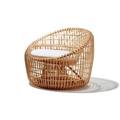 a chair made out of wicker sitting on top of a white floor