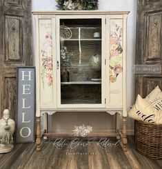 an old china cabinet with flowers painted on the doors and drawers is shown in this photo