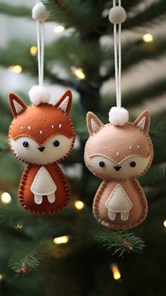 two ornaments hanging from a christmas tree with lights in the background and a fox on one ornament