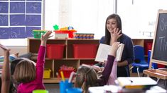 a teacher reading to children in a classroom