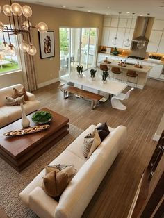 an aerial view of a living room and kitchen area in a house with hardwood floors