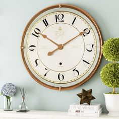 a large clock on the wall above a mantle