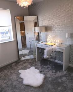 a bedroom with a vanity, mirror and chair next to a large white rug on the floor