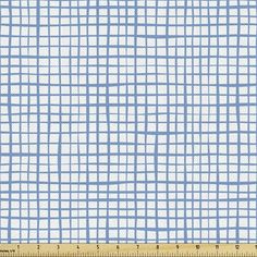 a blue and white checkered fabric with a ruler in front of the image, it is