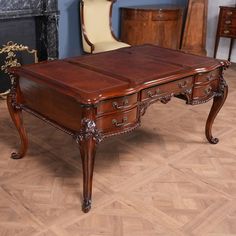 an antique desk in the middle of a room