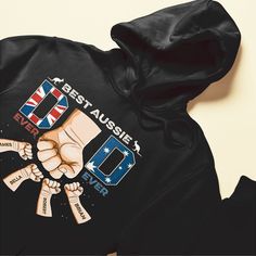 a black hoodie with the words best aussie dad on it and two fists