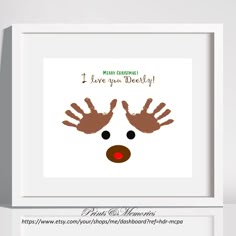 a christmas card with a reindeer's handprint on it