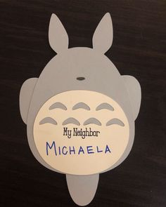 a close up of a paper cut out of a totoro face with the words my neighbor michaela on it