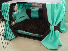 a dog bed with blue and brown pillows