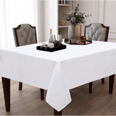 a white table cloth on top of a dining room table