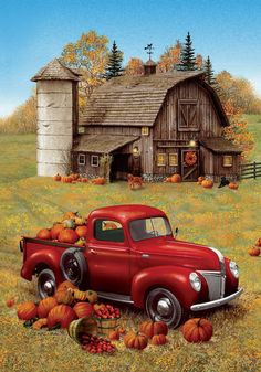 an old red truck parked in front of a barn with pumpkins on the ground