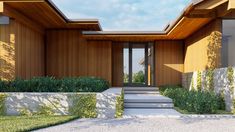 the entrance to a modern home with wood siding and stone steps leading up to it