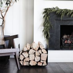 a fire place with logs in front of it