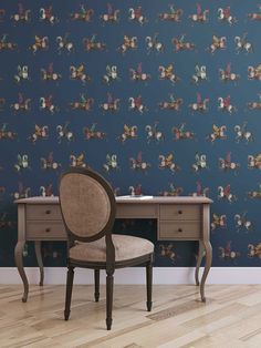 a chair sitting in front of a desk with a wallpapered background behind it