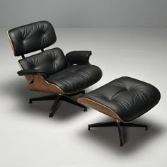 an eames lounge chair and ottoman in black leather