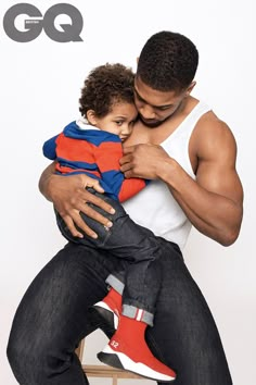 a man holding a small child in his arms