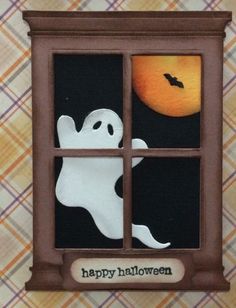 a window with a ghost in it that says happy halloween