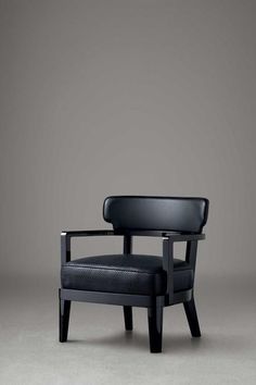 a black chair sitting on top of a gray floor